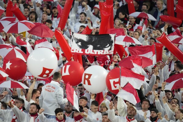 Freiburg supporters cheer before the Europa League round of 16 second leg soccer match between West Ham United and SC Freiburg at the London stadium in London, Thursday, March 14, 2024. (AP Photo/Kirsty Wigglesworth)