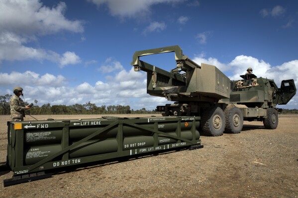 In this image provided by the U.S. Army, U.S. Army Sgt. Ian Ketterling, gunner for Alpha Battery, 1st Battalion, 3rd Field Artillery Regiment, 17th Field Artillery Brigade, prepares the crane for loading the Army Tactical Missile System (ATACMS) on to the High Mobility Artillery Rocket System (HIMARS) in Queensland, Australia, July 26, 2023. U.S. officials say Ukraine for the first time has begun using long-range ballistic missiles, called ATACMS, striking a Russian military airfield in Crimea and Russian troops in another occupied area overnight. (Sgt. 1st Class Andrew Dickson/U.S. Army via AP)