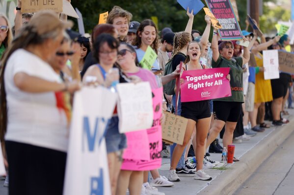 FILE - Zoe Staires protests against the U.S. Supreme Court overturning Roe v. Wade, June 24, 2022, in Tulsa, Okla. The Oklahoma Supreme Court reiterated its position on Tuesday, Nov. 14, 2023, in a 5-4 opinion that the Oklahoma Constitution guarantees a woman's right to an abortion when necessary to preserve her life, although the procedure remains illegal in virtually all other cases. (Mike Simons/Tulsa World via AP, File)