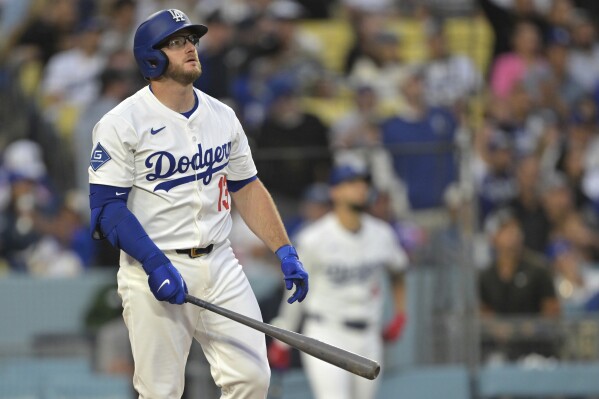Los Angeles Dodgers' Max Muncy watches the flight of the ball on a two-run home run during the first inning of a baseball game against the New York Mets, Tuesday, June 3, 2025, in Los Angeles. (AP Photo/Jayne Kamin-Oncea)