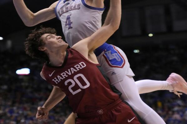 Kansas guard Gradey Dick (4) misses a layup while covered by Harvard guard Sam Silverstein (20) during the first half of an NCAA college basketball game Thursday, Dec. 22, 2022, in Lawrence, Kan. (AP Photo/Orlin Wagner)