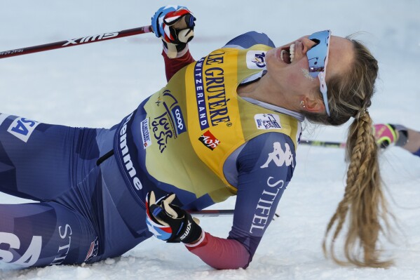 United States's Jessie Diggins celebrates winning the cross-country ski, women's Tour de Ski overall standings, in Val di Fiemme, Italy, Sunday, Jan. 7, 2024. (AP Photo/Alessandro Trovati)