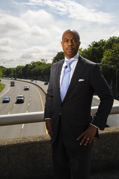 Tennessee State Rep. Harold Love, Jr. stands on an overpass over I-40, Monday, July, 19, 2021, near the site of his family's former home on the north side of Nashville, Tenn. Love Jr.'s father, a Nashville city councilman, was forced to sell his family home near this spot to make way for the highway, but put up a fight in the 1960s against the rerouting of Interstate 40 because he believed it would stifle and isolate Nashville's Black community. Love Jr. is now part of a group pushing to build a cap, across the highway behind. him, that creates a community space to help reunify the city. (AP Photo/John Amis)