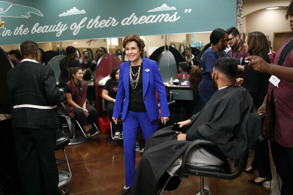 
              Rep. Jacky Rosen, D-Nev., center, walks through the Expertise Cosmetology Institute during an event for her Senate campaign, Friday, Nov. 2, 2018, in Las Vegas. Battleground races for U.S. Senate, U.S. House and governor will make Nevada voters Tuesday a key decider of power in Congress and the state’s political landscape for a decade. (AP Photo/John Locher)
            