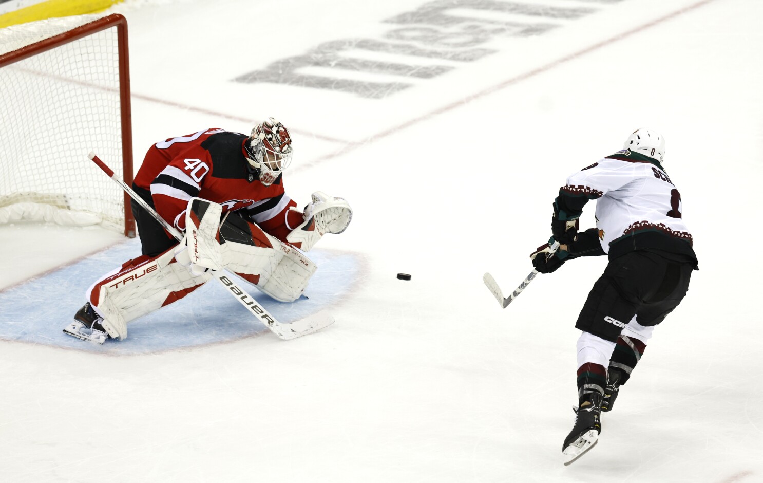 New Jersey Devils goaltender Akira Schmid (40) makes a save against the Tampa  Bay Lightning during the first period of an NHL hockey game Thursday, March  16, 2023, in Newark, N.J. (AP