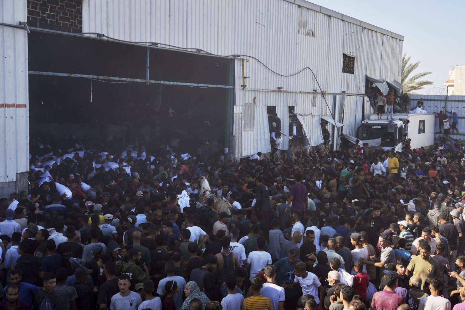 Four Palestinians die in storming of UN food warehouse a day after gunfire at new Gaza aid site