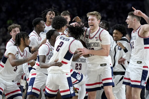 UConn players celebrate as time expires during the second half of the NCAA college Final Four championship basketball game against Purdue, Monday, April 8, 2024, in Glendale, Ariz. (AP Photo/Brynn Anderson)
