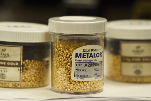 Containers holding gold granules are seen at A&M Precious Metals in the St. Vincent Jewelry Center in the Jewelry District of Los Angeles, Friday, May 2, 2025. (AP Photo/Jae C. Hong)