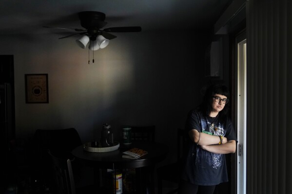 Beka Favela stands for a portrait at her Westmont, Ill., apartment, Tuesday, June 20, 2023. After a payment pause that has lasted more than three years, more than 40 million student loan borrowers will be on the hook for payments starting in the fall. (AP Photo/Charles Rex Arbogast)