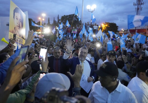 FILE - Guatemala's President-elect Bernardo Arévalo greets the crowd as he arrives at a march by Indigenous people to demand the resignation of Attorney General Consuelo Porras, outside the Supreme Court building in Guatemala City, Sept. 18, 2023. Arévalo won the Aug. 20 presidential runoff in a landslide, but prosecutors continued pursuing multiple investigations related to the registration of Arévalo’s Seed Movement party, and alleged fraud in the election. International observers have said that is not supported by evidence. (AP Photo/Moises Castillo, File)