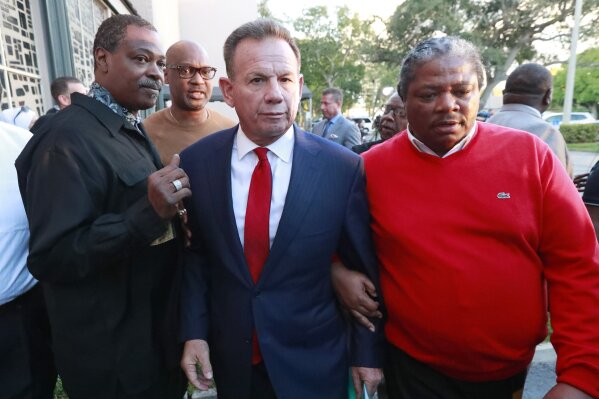 
              Suspended Broward County Sheriff Scott Israel, center, leaves a news conference surrounded by supporters Friday, Jan. 11, 2019, in Fort Lauderdale, Fla., after new Florida Gov. Ron DeSantis suspended him, over his handling of last February's massacre at Marjory Stoneman Douglas High School. (AP Photo/Wilfredo Lee)
            