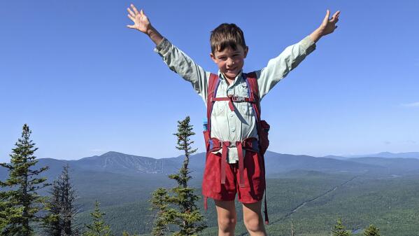 In this July 23, 2021, family photograph provided by Joshua Sutton, 5-year-old Harvey Sutton raises his arms on a mountain top in Bigelow Preserve, Maine, while hiking the Appalachian Trail with his Mom and Dad. Know by the trail name as "Little Man," Harvey tagged along with his parents over more than 2,100 miles over 209 days to complete the family feat. (Joshua Sutton via AP)