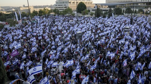 Israelis protest against Prime Minister Benjamin Netanyahu's judicial overhaul plan outside the parliament in Jerusalem, Sunday, July 23, 2023. The protest came as lawmakers were debating the plan ahead of an expected vote on Monday. (AP Photo/Mahmoud Illean)