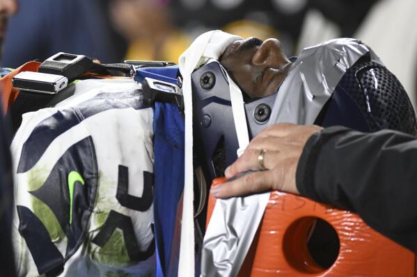 Seattle Seahawks defensive end Darrell Taylor (52) is carted off the field after being injured during the second half an NFL football game against the Pittsburgh Steelers, Sunday, Oct. 17, 2021, in Pittsburgh. (AP Photo/Fred Vuich)