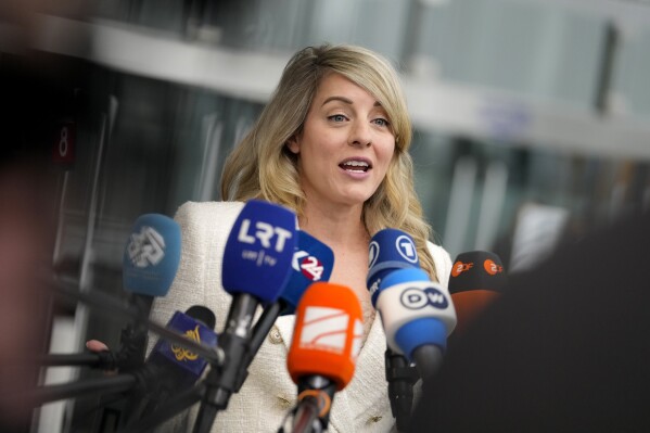 Canada's Foreign Minister Melanie Joly speaks with the media as she arrives for a meeting of NATO foreign ministers at NATO headquarters in Brussels, Wednesday, April 3, 2024. NATO foreign ministers gathered in Brussels on Wednesday to debate plans to provide more predictable, longer-term support to Ukraine. (AP Photo/Virginia Mayo)