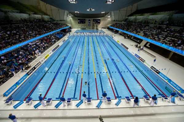 FILE - A general view show a women's 400m medley heat during the British Swimming Championship selection trials and Olympic test event at the London 2012 Olympic Aquatics Centre at the Olympic Park in London, on March 3, 2012. An independent report looking into England's swimming federation has revealed a toxic culture of fear at clubs across the country where bullying and aggressive coaching can go unchecked. England's national governing body for swimming published the findings of the research it commissioned on Tuesday March 5, 2024, expressing its commitment to implement change. (AP Photo/Matt Dunham, File)