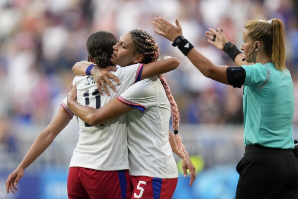 United States' Sophia Smith celebrates with Trinity Rodman the opening goal during a women's semifinal soccer match between the United States and Germany at the 2024 Summer Olympics, Tuesday, Aug. 6, 2024, at Lyon Stadium in Decines, France. (AP Photo/Silvia Izquierdo)