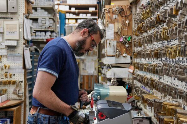 Employee Jon Vazquez-DeAnda cuts keys for a customer at employee-owned Clark Devon Hardware, Wednesday, April 2, 2025, in Chicago. (AP Photo/Erin Hooley)