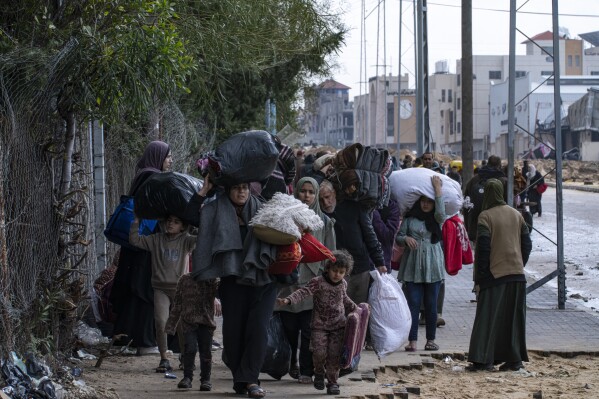 CORRECTS CITY TO KHAN YOUNIS, INSTEAD OF RAFAH - Palestinians flee from the city of Khan Younis in southern Gaza after an Israeli ground and air offensive on Monday, Jan. 29, 2024. Israel has expanded its offensive in Khan Younis, saying the city is a stronghold of the Hamas militant group. (AP Photo/Fatima Shbair)