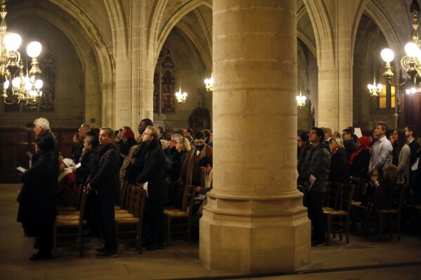 Believers the christmas mass, in Saint-Germain l'Auxerrois church, in Paris, Tuesday, Dec. 24, 2019. Notre Dame Cathedral is unable to host Christmas services for the first time since the French Re...