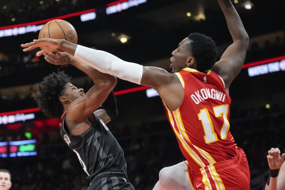 Houston Rockets guard Jalen Green (4) shoots as Atlanta Hawks forward Onyeka Okongwu (17) defends during the first half of an NBA basketball game Saturday, Feb. 10, 2024, in Atlanta. (APPhoto/John Bazemore)