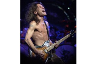 FILE - In this Aug. 5, 2004 file photo, Van Halen guitarist Eddie Van Halen performs in Phoenix. Van Halen, who had battled mouth cancer, died Tuesday, Oct. 6, 2020. He was 65. (AP Photo/Tom Hood, File)