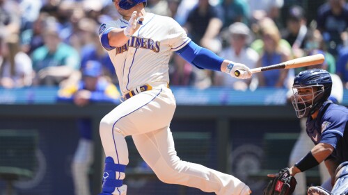 Seattle Mariners' Ty France follows through on an RBI double to score Julio Rodriguez against the Tampa Bay Rays during the third inning of a baseball game, Sunday, July 2, 2023, in Seattle. (AP Photo/Lindsey Wasson)