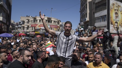Mourners chant slogans against Israel while carrying the body of Badr al-Masri, 19, during his funeral in the West Bank city of Nablus, Thursday, July 20, 2023. Israeli troops shot and killed a Palestinian man near a shrine in the occupied West Bank on Thursday, Palestinian health officials said, in the latest bloodshed in a cycle of violence that has gripped the region. The Israeli military said that suspects opened fire and threw explosives, rocks and burning tires at troops, who returned fire. (AP Photo/Nasser Nasser)