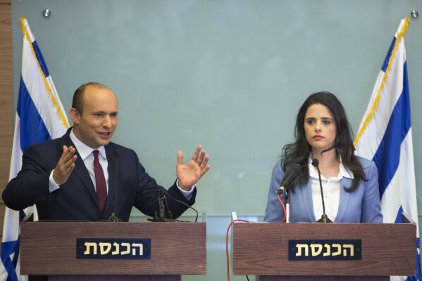 
              Israeli Education Minister Naftali Bennett, left, and Israeli Justice Minister Ayelet Shaked gesture as they speak during a press conference at the Knesset, Israel's parliament in Jerusalem, Monday, Nov. 19, 2018. Bennett, a senior coalition partner in Israel's government says he will not resign, averting early elections for now. (AP Photo/Sebastian Scheiner)
            