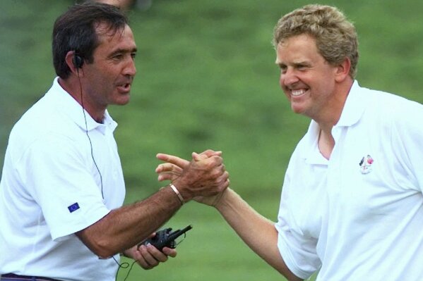 FILE - European Ryder Cup team captain Seve Ballesteros congratulates Scotland's Colin Montgomerie after he holed a putt on the 17th green to go one up in his fourball match on day two of the Ryder Cup at Valderrama golf coursein Valderrama, Spain, Saturday Sept. 27, 1997. Europe won in Spain to start three decades of never losing the Ryder Cup at home.(AP Photo/Elise Amendola, File)