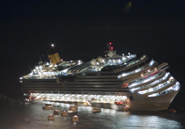 FILE - In this picture taken on Jan. 13, 2012, the luxury cruise ship Costa Concordia lays on its starboard side after it ran aground off the coast of the Isola del Giglio island, Italy, gashing open the hull and forcing some 4,200 people aboard to evacuate aboard lifeboats. (AP Photo/Giuseppe Modesti)