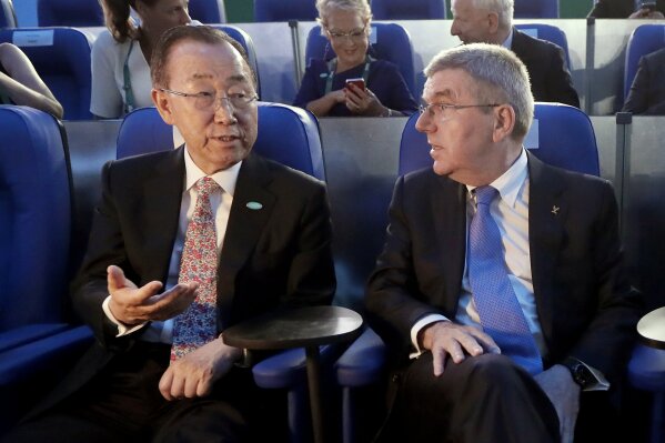 FILE - In this Aug. 5, 2016, file photo, then U.N. Secretary-General Ban Ki-moon, left, talks with International Olympic Committee President Thomas Bach in Maracana Stadium before the opening ceremony for the 2016 Summer Olympics in Rio de Janeiro, Brazil. Ban is being asked to rule on an ethics complaint filed against the International Olympic Committee by a human-rights group representing Uyghurs and other ethnic minorities in China. (AP Photo/Mark Humphrey, Pool)