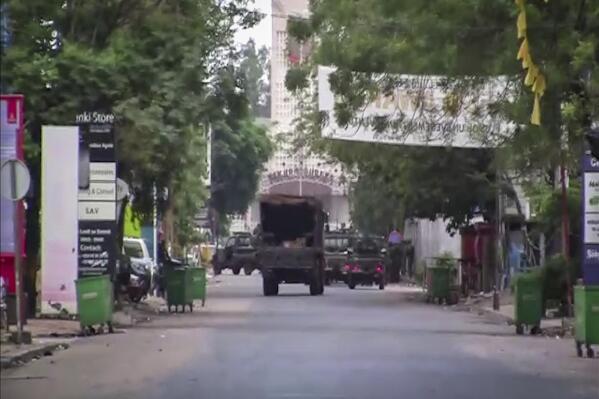 In this image made from video, a military truck is seen near the presidential palace in the capital Conakry, Guinea Sunday, Sept. 5, 2021. Mutinous soldiers detained President Alpha Conde on Sunday after hours of heavy gunfire rang out near the presidential palace, then announced on state television that the government had been dissolved in an apparent coup d'etat. (AP Photo)