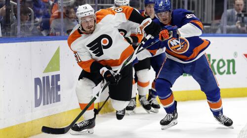 Philadelphia Flyers defenseman Justin Braun (61) skates with the puck past New York Islanders right wing Hudson Fasching in the second period of an NHL hockey game Saturday, April 8, 2023, in Elmont, N.Y. (AP Photo/Adam Hunger)