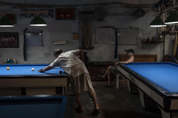 A man plays pool in Ho Chi Minh City, Vietnam, Jan. 13, 2024. (AP Photo/Jae C. Hong)