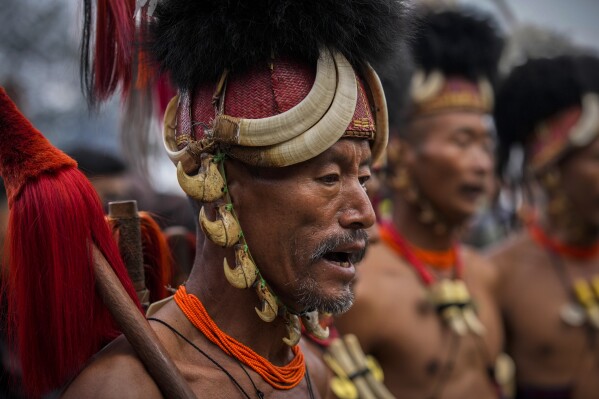 Indigenous Nagas perform a warrior dance dance during the Hornbill Festival in Kisama, on the outskirts of Kohima, capital of the northeastern Indian state of Nagaland, Tuesday, Dec. 10, 2024. (AP Photo/Anupam Nath)