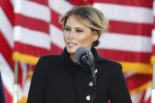 FILE - Then First lady Melania Trump speaks to a small group of supporters as President Donald Trump looks on at Andrews Air Force Base, Md., Jan. 20, 2021. (AP Photo/Luis M. Alvarez, File)