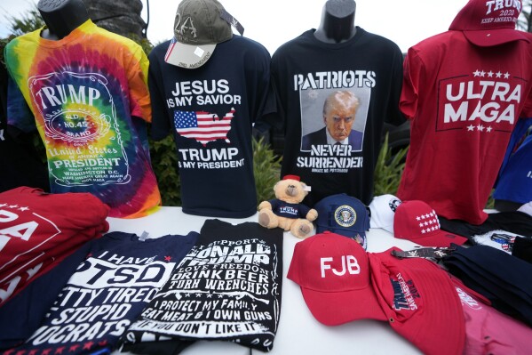 T-shirts are sold outside the 2023 California Republican Convention where former President Donald Trump is speaking, in Anaheim, Calif., Friday, Sept. 29, 2023. (AP Photo/Damian Dovarganes)