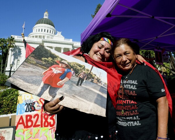 FILE - Farmworkers Cynthia Burgos, left and Teresa Maldonado, right, hug after Gov. Gavin Newsom signed a bill aimed at making it easier for farmworkers to unionize in Sacramento, Calif., Sept. 28, 2022. A battle between The Wonderful Co. which grows pistachios, pomegranates, citrus and other crops and United Farm Workers is over new rules in California aimed at making it easier for farmworkers to form unions. (AP Photo/Rich Pedroncelli, File)