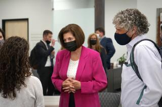 Sen. Catherine Cortez Masto, D-Nev., center, meets with people after speaking about the infrastructure bill at the Reno-Sparks Chamber of Commerce in Reno, Nev., Monday Aug. 23, 2021. Cortez Masto said infrastructure investments, tax credits for renewable energy projects and incentives to site solar and wind projects on former mines, would create jobs and protect the environment for future generations.  (AP Photo/Samuel Metz.)