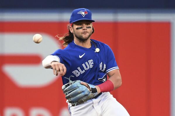 Toronto Blue Jays shortstop Bo Bichette throws to first base to put out Boston Red Sox's Trevor Story during the fourth inning of a baseball game Tuesday, June 28, 2022, in Toronto. (Jon Blacker/The Canadian Press via AP)