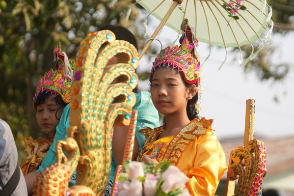 A child who is to become a Buddhist nun rides on a decorated cow cart during a processional parade as part of a celebration of a novitiation or “Shinbyu,” ceremony, Saturday, March 15, 2025, at Hlegu township, outside of Yangon, Myanmar. (AP Photo/Thein Zaw)
