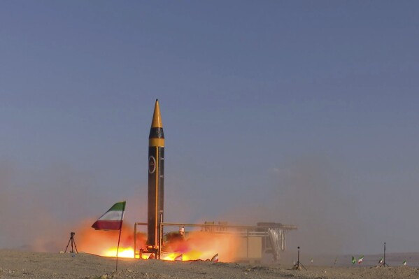 FILE - In this photo released by the Iranian Defense Ministry on May 25, 2023, Khorramshahr-4 missile is launched at an undisclosed location, Iran. The U.S. on Oct. 18, imposed sanctions on a group of people and firms based in Iran, China, Hong Kong and Venezuela, tied to the development of Iran's ballistic missile and drone programs. The penalties come as the United Nations' restrictions on Iran missile-related activities under a Security Council Resolution are set to expire, as well as the E.U. restrictions on Iran's ability to obtain nuclear and conventional arms.(Iranian Defense Ministry via AP)