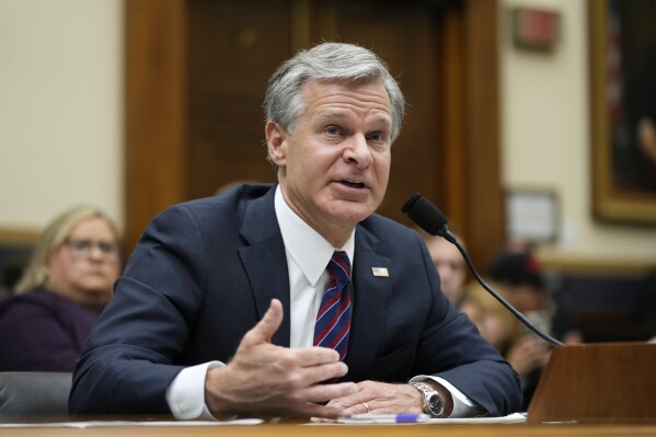 FILE - FBI Director Christopher Wray testifies before a House Committee on the Judiciary oversight hearing, July 12, 2023, on Capitol Hill in Washington. Wray spoke to one of the nation's largest police groups on Saturday, Oct. 14 about how the agency works with police around the country, including helping secure an indictment against two men accused in the death of a small-town Michigan teenager caught in an international online sexual extortion scheme. There's recently been a sharp in increase in such cases. (AP Photo/Patrick Semansky, File)