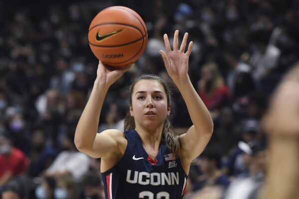 FILE -Connecticut's Caroline Ducharme shoots during UConn's men's and women's basketball teams annual First Night celebration, Friday, Oct. 15, 2021 in Storrs, Conn. UConn guard Caroline Ducharme will miss the remainder of the season with ongoing head and neck problems, the school announced Tuesday, Jan. 23, 2024. (AP Photo/Jessica Hill, File)