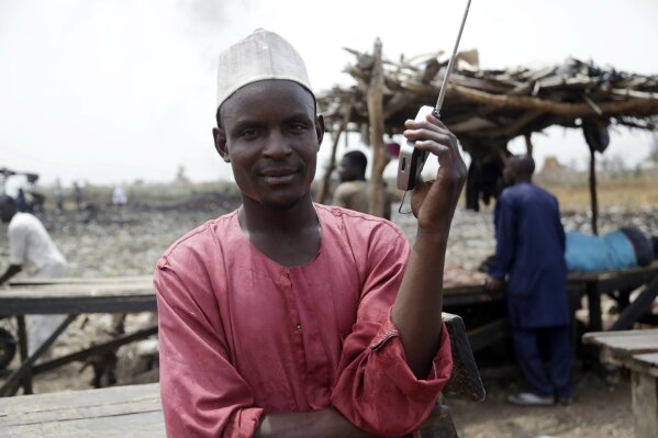 
              Umaru Hassan listens to Presidential elections result on a transistor radio in Yola, Nigeria, Monday Feb. 25, 2019. Official results of Nigeria's presidential election are expected as early Monday in what is being seen as a close race between Incumbent President Muhammadu Buhari and opposition candidate Atiku Abubakar (AP Photo/Sunday Alamba)
            