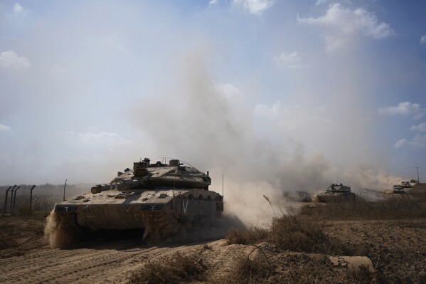 Israeli tanks head towards the Gaza Strip border in southern Israel on Friday, Oct.13, 2023. (AP Photo/Ariel Schalit)