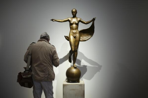 A journalist makes some notes in front of the 'Model of Fortuna' by artist Richard Scheibe at the exhibition 'Divinely Gifted List' at the German Historic Museum in Berlin, Germany, Wednesday, Aug. 25, 2021. A new show examining how some of the Nazi's favorite artists were able to successfully continue their work in postwar Germany is set to open in Berlin this week. The exhibition at the German Historical Museum traces the lives and creations of several artists who made it onto the so-called 'Divinely Gifted List' from 1944, which was compiled on behalf of Adolf Hitler and other top Nazis. (Photo/Markus Schreiber)