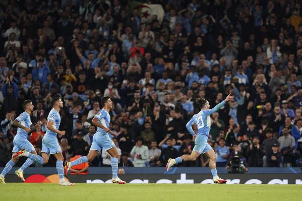 Manchester City's Jack Grealish, right, celebrates with teammates after scoring during the Champions League Group A soccer match between Manchester City and RB Leipzig at the Etihad Stadium, Manchester, England, Wednesday Sept. 15, 2021. (Zac Goodwin/PA via AP)