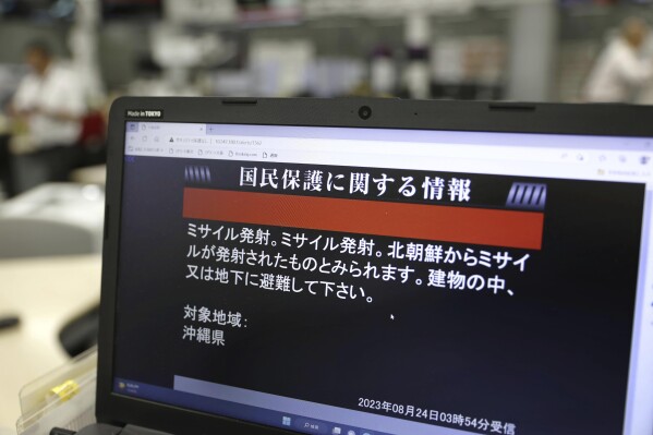 A monitor in Tokyo shows J-Alert or National Early Warning System to the residents in Okinawa, southern Japan, Thursday, Aug. 24, 2023. North Korea said Thursday that its second attempt to launch a spy satellite failed again but vowed to make another attempt in October, demonstrating willingness to endure flops to acquire a key military asset coveted by leader Kim Jong Un. The failed launch prompted neighboring Japan to issue brief a “J-alert” ordering some residents to evacuate to safe places as the North Korean rocket flew over its southernmost islands of Okinawa to the Pacific Ocean. The screen reads " Missile launched, Missile launched. It seems missile was launched from North Korea. Please take shelter inside buildings or underground. " (Kyodo News via AP)
